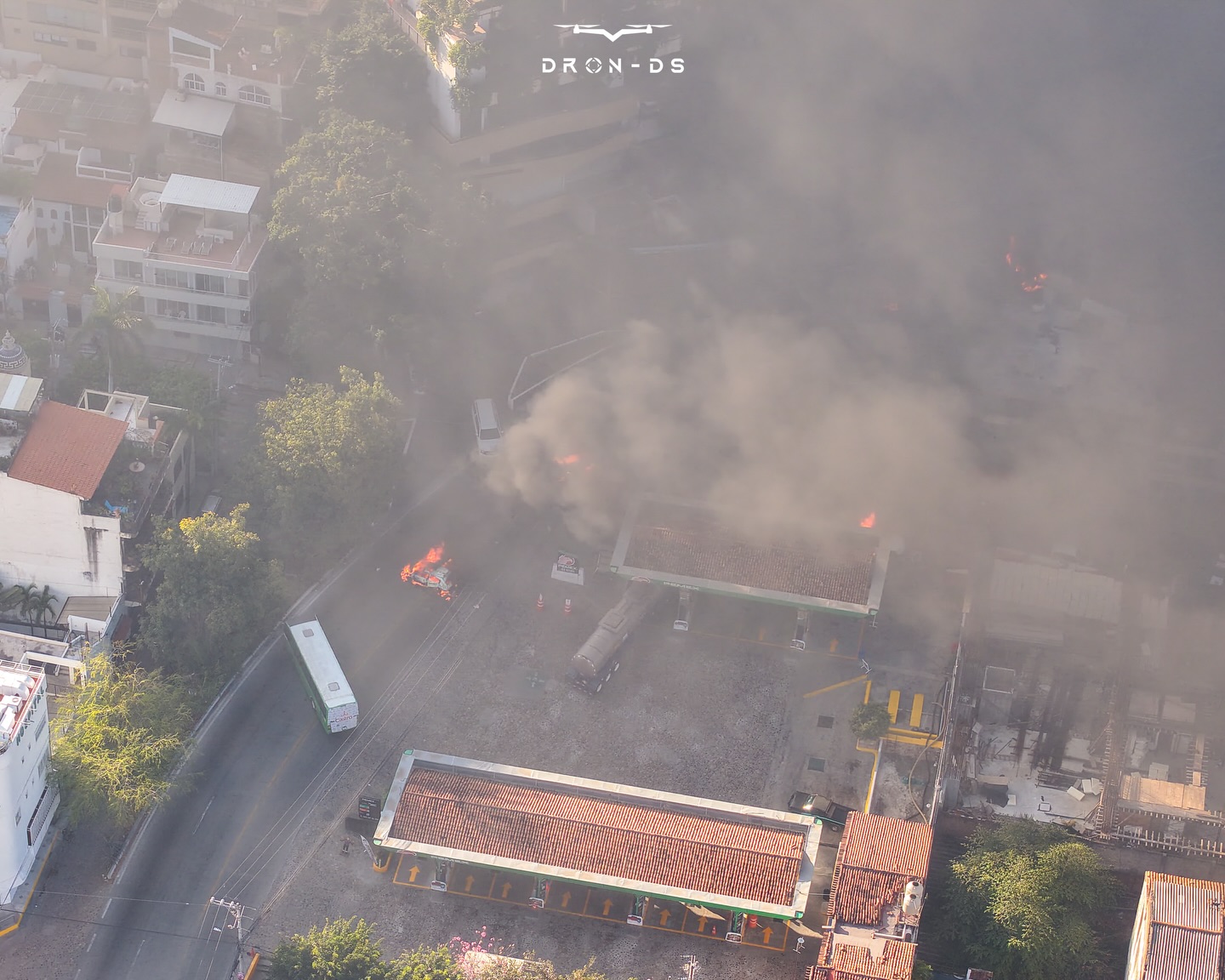 an aerial shot of vehicles on fire on a city street